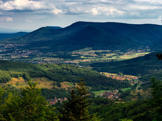 Fototapeta na wymiar Spacious mountain landscape. A view from the mountain to the valley of Rhine and the village of Alsace.