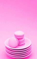 Obraz na płótnie Canvas Macaroon on a stack of light pink saucers.