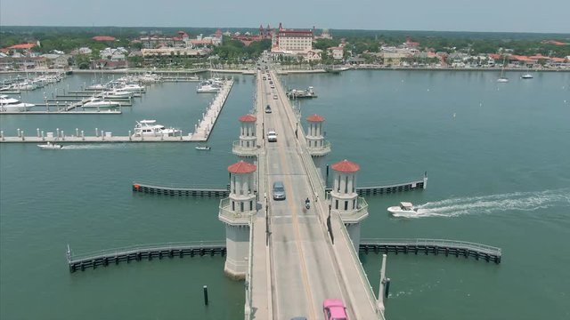 Aerial: Traffic driving over the Bridge of Lions on the Matanzas River. In the background is the city of St Augustine, Florida, USA