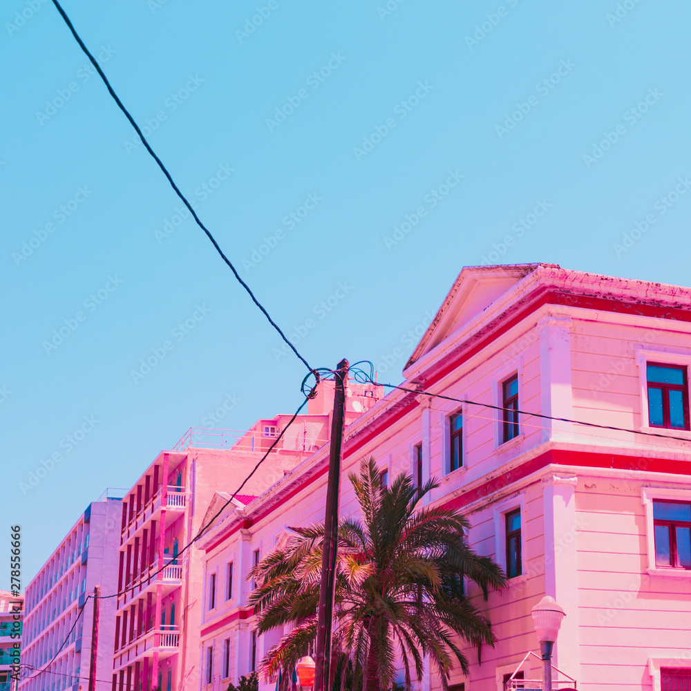 Wall mural pink hotel and palm tree in infrared style