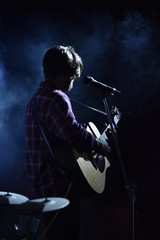 young man playing a guitar