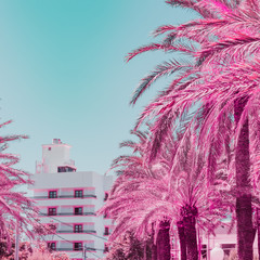 Part of beach hotel and palms in infrared style. Surreal tropical travel concept. Soft light pink...