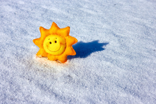 Decorative handmad textile funny sun on melting snow in early spring