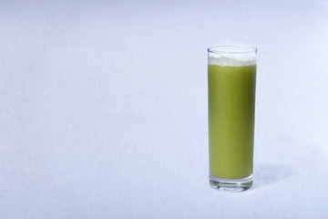 green juice with natural fruits on white background