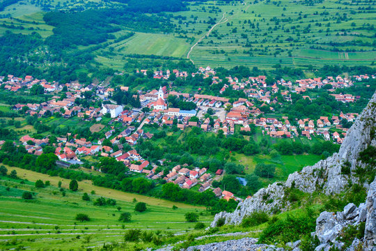 Rimetea village seen from a rock climbing route, part of Rimetea Climbing Open (RICO), in Trascau Mountains, Romania. Church and traditional Transylvanian houses creating a pattern - aerial view.
