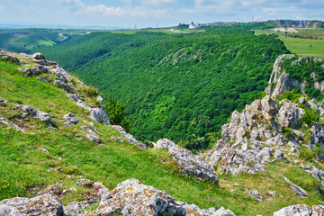 Fototapeta na wymiar Tureni-Copaceni gorge - top view from the ridge towards the forest at the entrance from Copaceni village. Also called Cheile Turului (or Turi hasadek in Hungarian), this is a protected natural area.