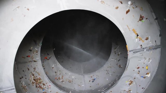 rotating spiral detail with wastepaper and steam at plant
