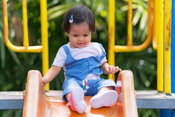 Happy small child on the playground in the park