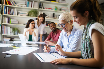 Group of successful business people at work in office