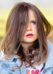 Fototapeta premium portrait of little girl outdoors in summer