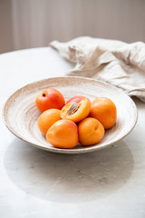 Wicker basket apricot on a marble background with copy space and daylight