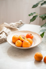 Wicker basket apricot on a marble background with copy space and daylight