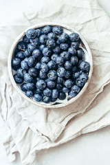Blueberry bowl on white background with copy space in rustic style