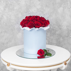 Bouquet of flowers in a hat box on the table