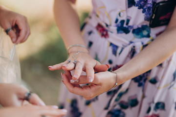 the girl examines the rings on her hands