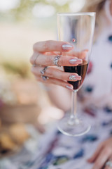 girl holding a glass of red champagne