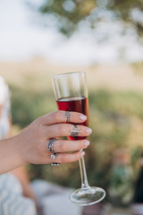 girl holding a glass of red champagne