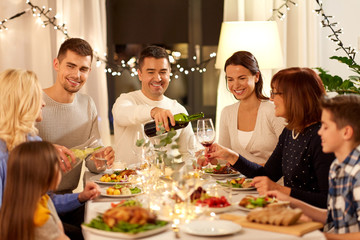 celebration, holidays and people concept - happy family having dinner party at home