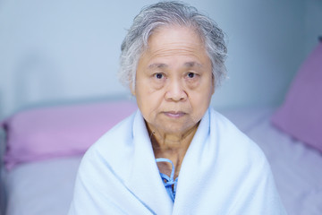 Fototapeta na wymiar Asian senior or elderly old lady woman patient smile bright face while sitting on bed in nursing hospital ward : healthy strong medical concept 