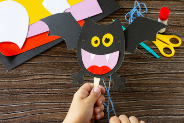 The child plays of dracola bat toy Halloween. Children's art project, craft for children. Craft for...