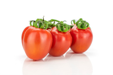 Group of three whole fresh red tomato cherry isolated on white background