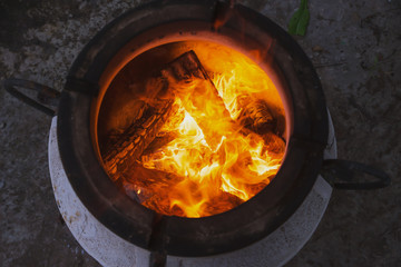 fire with charcoal in a compact home tandoor at the cottage