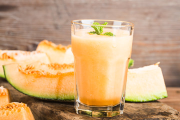 The juice of melon with mint in a glass jar on the table.Hami melon