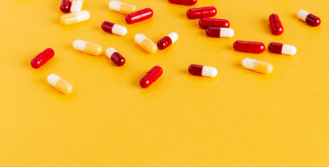 Scattered yellow and red drug capsules with active microgranules