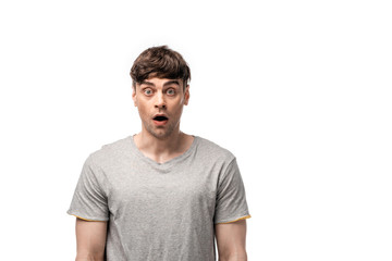 Obraz premium shocked young man in grey t-shirt looking at camera isolated on white