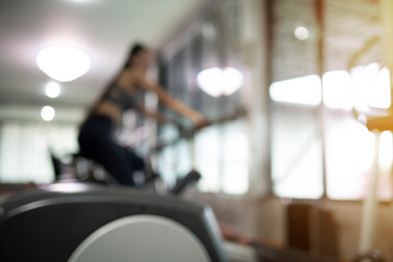 Strong woman exercise on bicycle in the  fitness gym