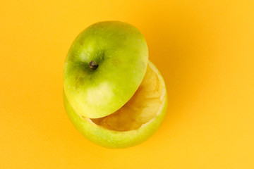 Healthy Green Cut Apple floating top slice juice drink idea concept on yellow background