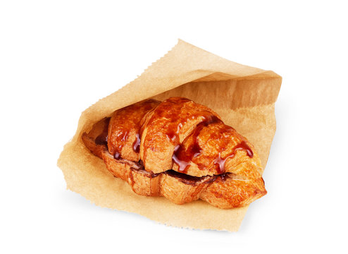 Croissant with chocolate topping on a white background