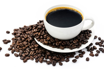 Black coffee in a white coffee cup and coffee beans on a white background