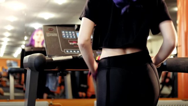 Sport training. Backview of athletic woman running on treadmill showing off fit ass
