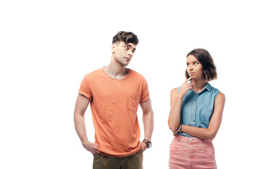 Fototapeta premium offended boyfriend looking at thoughtful girl isolated on white