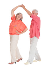 Portrait of happy senior couple dancing on white background