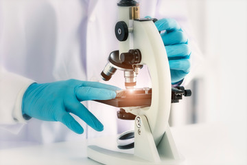 Laboratory concept; The Scientist is using microscope in analytical laboratory.