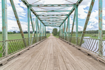 old green steel bridge in the countryside