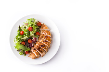 Grilled chicken breast with vegetables on a plate isolated on white background. Top view. Copyspace
