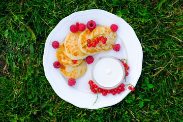 The concept of healthy eating. Cheesecakes with sour cream and raspberries