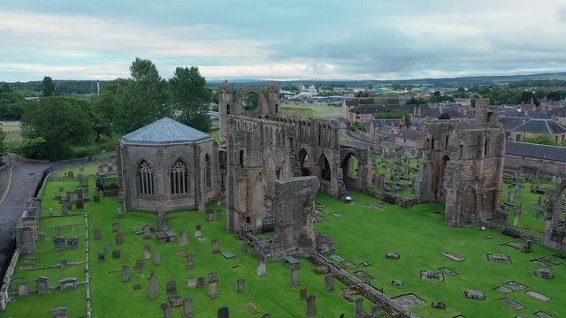 Aerial view of ruins of Elgin Cathedral, dilapidated medieval church building, stone structure in Gothic style - landscape panorama of Scotland from above, United Kingdom, Great Britain, Europe