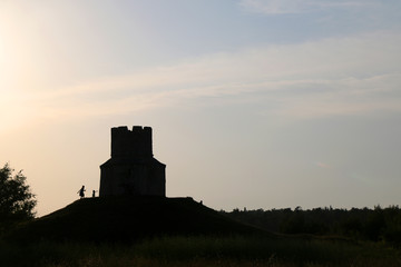 Obraz premium Silhouette of small medieval church of St. Nicholas and visitors around, near Nin, Croatia.