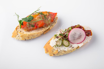 Canape mini bruskety sandwiches with fresh and steamed vegetables. Beautifully decorated catering banquet menu. Food snacks and appetizers for buffet. Isolated on white background