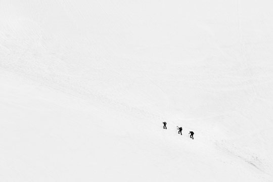 Three Lonely Isolated Climbers Climbing A Mountain In French Alps Near Chamonix