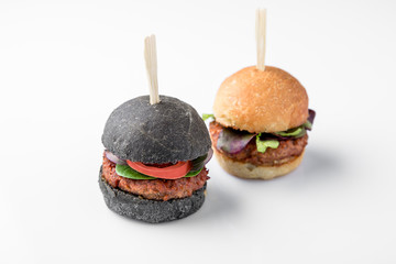 Vegetarian mini meat burgers. Beautifully decorated catering banquet menu. Food snacks and appetizers for buffet. Isolated on white background