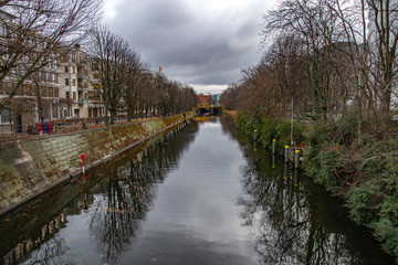 Fototapeta premium Canal in Berlin. Autumn landscape of Spree river in Berlin Germany. View from bridge to embankments by riverbanks.