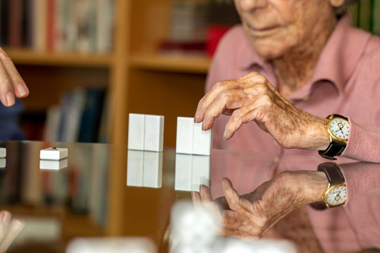 Detail Of Senior Woman's Hand Playing Dominos.