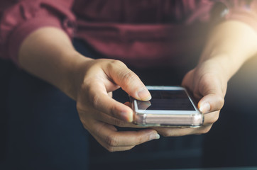 hipster woman using hands touching and typing on mobile phone screen search internet online working or social communication with digital technology app device in coffee shop indoor vintage lifestyle.