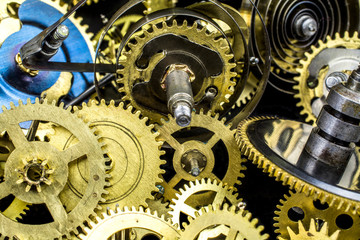 Background of bronze gears from the clock close-up.