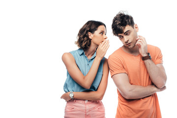 attractive young woman whispering to thoughtful man isolated on white